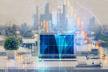 Stock market graph and table with computer background. Double exposure. Concept of financial analysis.