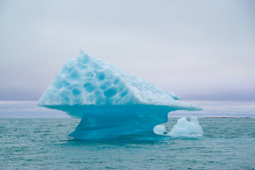 Drifting iceberg in the shape of a mushroom in the Arctic on Spitsbergen