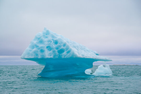 Drifting iceberg in the shape of a mushroom in the Arctic on Spitsbergen
