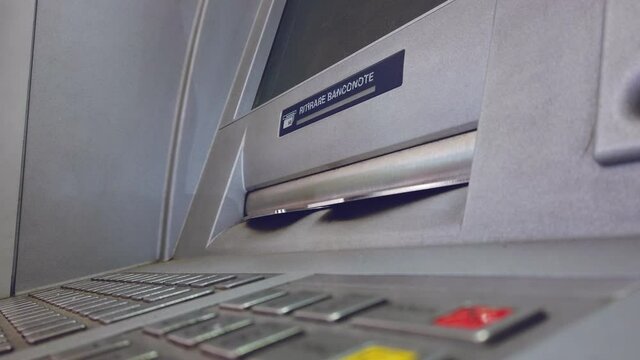ATM machine hand taking cash bank withdrawal service