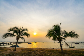 Fototapeta na wymiar Coconut trees on the beach During sunset at bang phra sriacha chonburi thailand