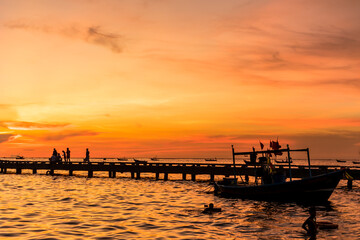 Silhouette of Harbor bridge and people during sunset at Bang Phra Beach,sriracha choburi,thailand