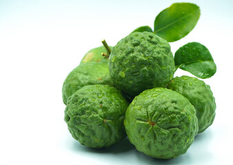 Fototapeta premium Fresh bergamot fruit with leaf and cut in half of bergamot on white background