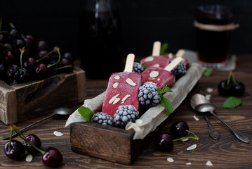berry ice cream on a stick of cherry, raspberry, blackberry and mint.