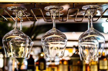 Wine glasses hanging with blurry background