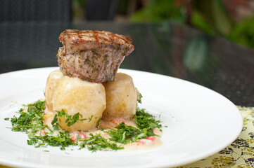 New potatoes with steak. Serving meals in a restaurant.