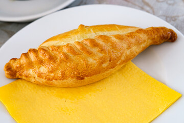 A Kibinai served on a plate with napkin. Kibinai is a traditional Lithuanian dish that are the national dish of the Kariate people, an ethnically Turkic group that has lived in Lithuania for centuries