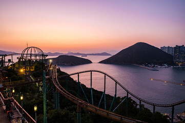 Obraz premium Roller Coaster track along the coastline during sunset