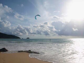 Kite surfing on the beach. Kiteboarding, kitesurfing an action sport combining wakeboarding, snowboarding, windsurfing, surfing, paragliding, skateboarding and sailing into one extreme sport. Thailand