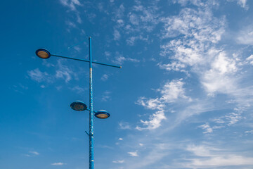 Lamppost against the sky and clouds