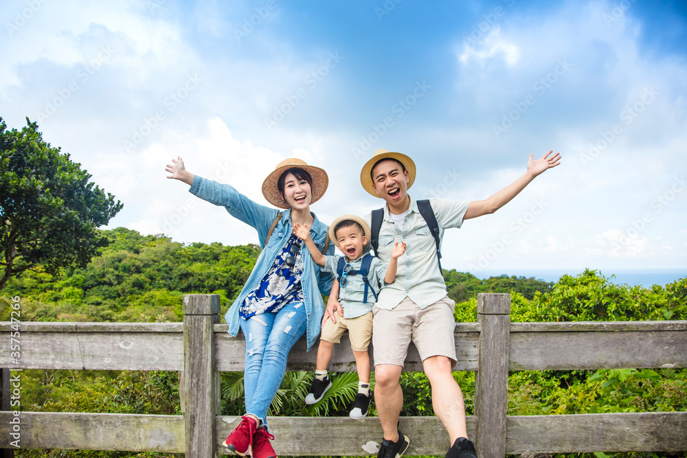 Wall mural happy asian family on hiking adventure