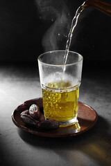 Arab chrysanthemum tea and dates fruit  on a concrete background