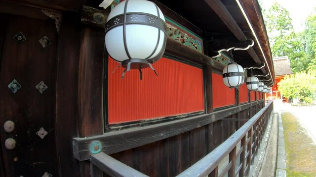 Traditional white paper lightings (chochin) along the roof of Kitano Tenmangu shrine. Kyoto. Japan