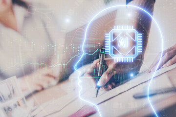 Double exposure of woman's writing hand on background with brain hud. Concept of learning.