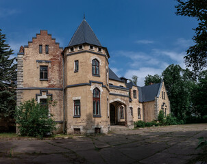 Fototapeta na wymiar Beautiful old abandoned castle under a blue sky