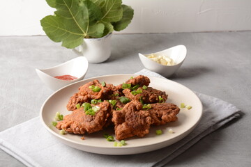 Fish in batter. Homemade Battered Fish Fry on the plate with fresh green onions. 