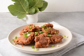 Fish in batter. Homemade Battered Fish Fry on the plate with fresh green onions. 