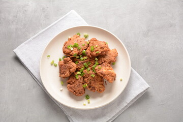 Fish in batter. Homemade Battered Fish Fry on the plate with fresh green onions. 