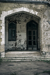 Entrance with door and window to an old abandoned house