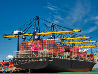The container vessel  during discharging at an industrial port.