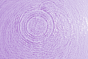 Fototapeta na wymiar texture of splashing clean water on purple background