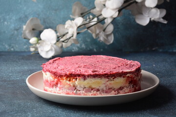 Layered salad with herring, beets, carrots, onions, potatoes and eggs. 