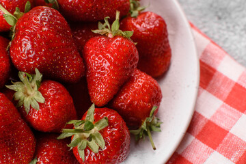Beautiful juicy fresh strawberries on the concrete surface of the table