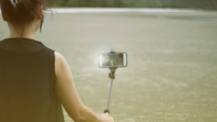  a view of woman taking selfie. blurred.               