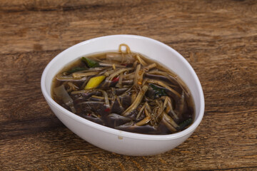 Thai style soup with meat and mushrooms