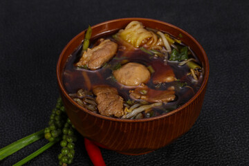 Thai style soup with meat and mushrooms