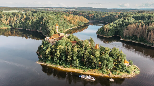 Aerial beautiful view of Zvikov Castle, Czech Republic.Picturesque landscape with castle, trees and water.Spring scenery by sunset.Gothic castle standing on a rock above the confluence of two rivers