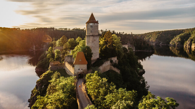 Aerial beautiful view of Zvikov Castle, Czech Republic.Picturesque landscape with castle, trees and water.Spring scenery by sunset.Gothic castle standing on a rock above the confluence of two rivers