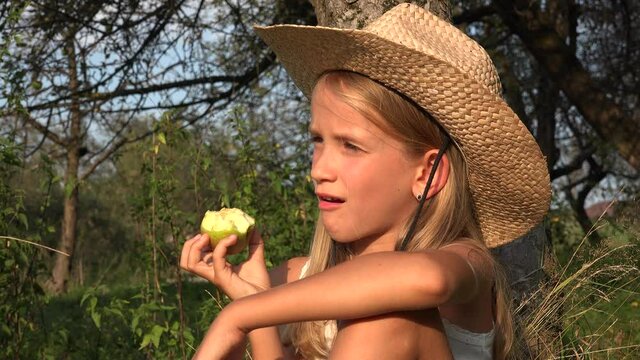 Kid Eating Apple in Yard at Village, Farmer Child in Orchard, Girl Tasting Fruits Outdoor in Nature