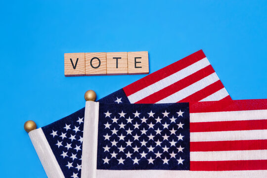 Two American Flags with the sign of the wooden letters - VOTE