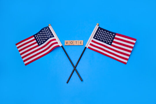 Two American Flags with the signs of the wooden letter - VOTE
