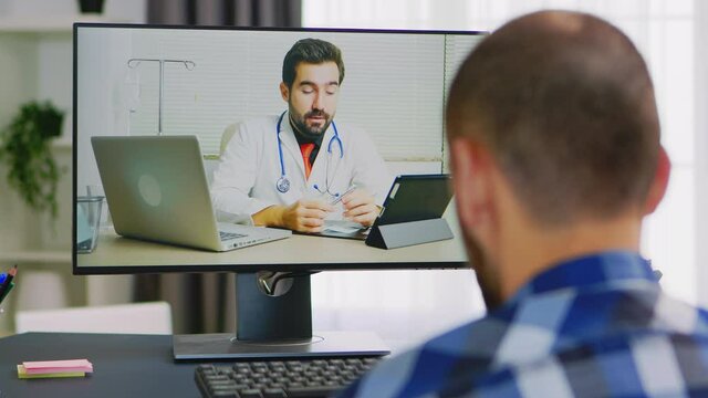 Patient on video call with doctor talking about his rehabilitation. Handicapped invalid paralysed freelancer, immobilized entrepreneur working from home, ilness and disability