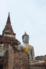 Sitting Buddha statue in front of pagoda