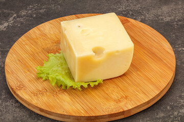 Emmental cheese over wooden board