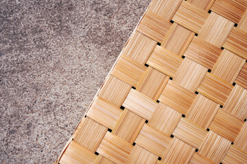 Asian style of bamboo weave pattern on cement floor , natural material combination and contrast concept 