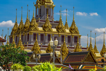 Background of tourist attractions where people come to see the beauty of the architecture of the golden pagoda in Bangkok (Wat Metal Prasat Or Wat Ratchanaddaram Worawihan) in Thailand