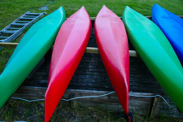 Stockholm, Sweden  Upside down canoes on the grass.