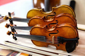 Classical violins standing on a table. © Victor