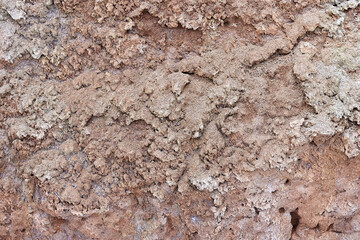 Texture of different layers of clay on the edge of a cliff. Closeup