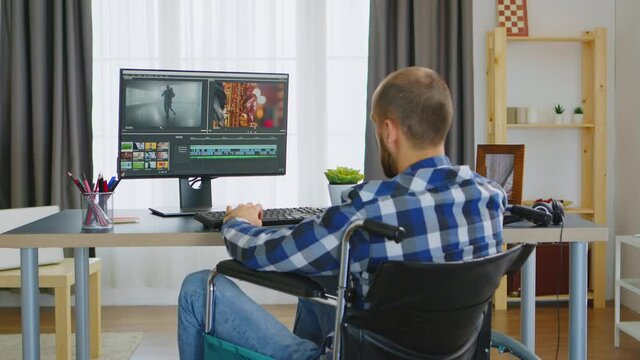 Content creator with walking disability in wheelchair working on one of his project. Handicapped invalid paralysed freelancer, immobilized entrepreneur working from home, ilness and disability