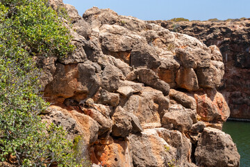 Wallabies hiding at the creek between the rocks with shade near a river at Yardie Creek, Cape Range National Park, Australia, West Australia WA