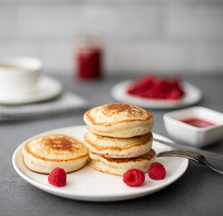 pancakes with raspberry jam, sour cream and powdered sugar