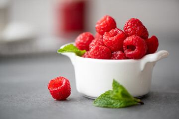 berries of fresh large raspberries in a white bowl