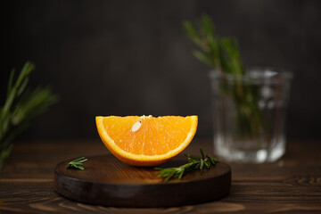 ripe orange sliced on a wooden board