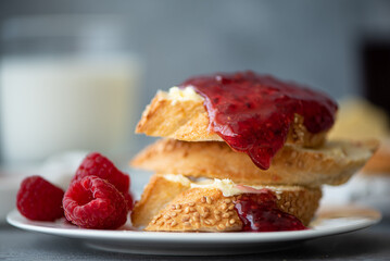 toasted baguette with butter and raspberry jam