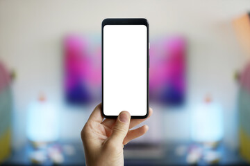 Man hand holding smartphone on blur background. Screen mockup